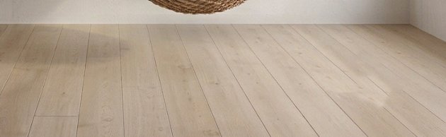 Floor with a single soft shadow beneath the chair.